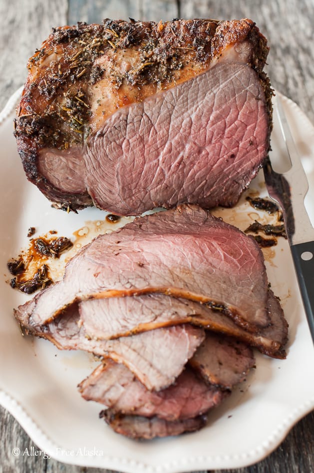 cooked and sliced bottom round roast beef sitting on platter