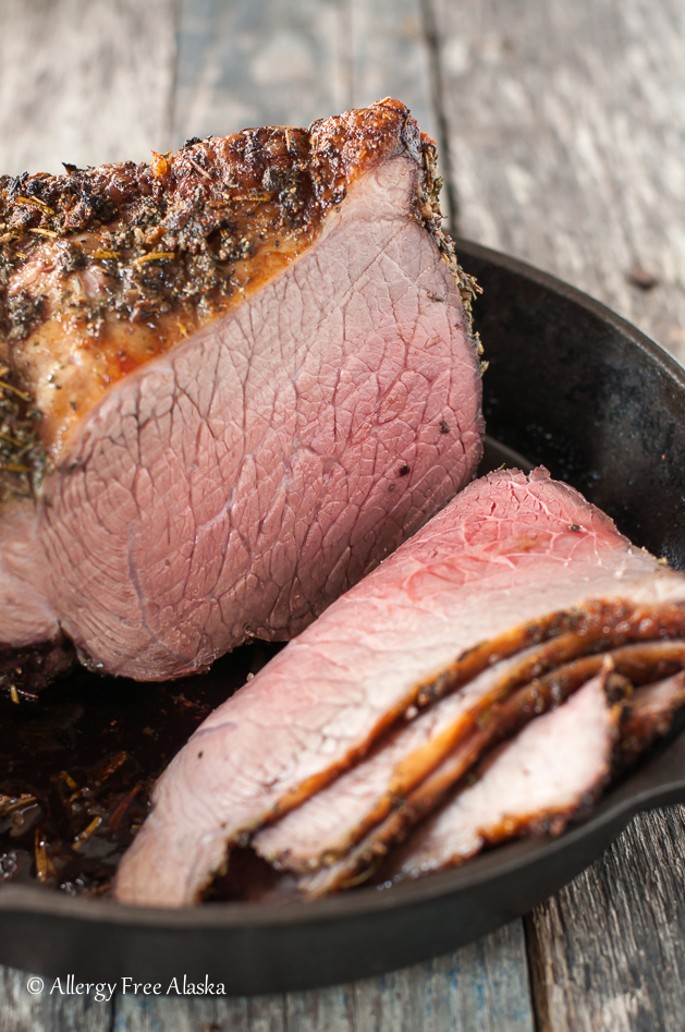 sliced bottom round roast sitting in pan