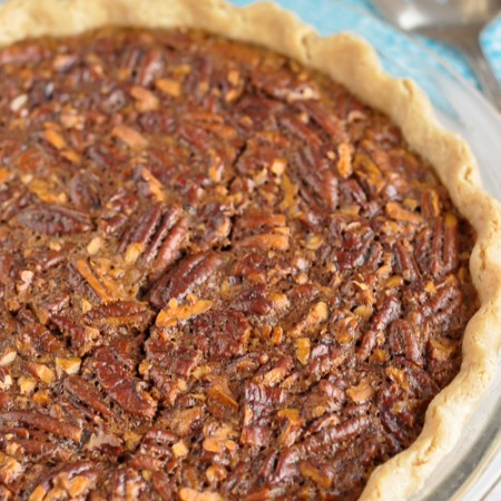 whole gluten-free pecan pie waiting to be sliced and served