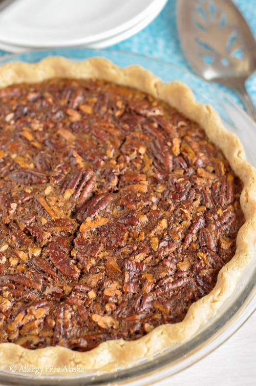 whole uncut Gluten-Free Pecan Pie on table ready to cut and serve