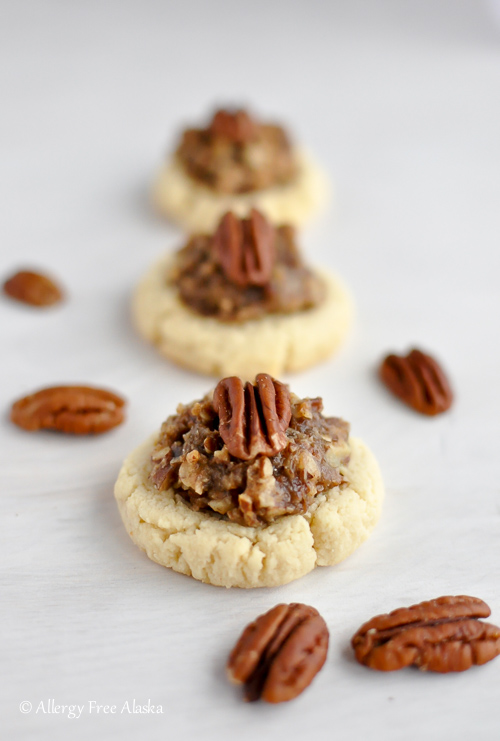 Photo shows several pecan cookies lined up on a white table