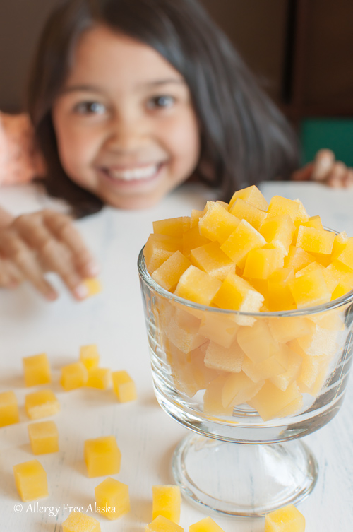 Bowl of real fruit gummies with child in the background