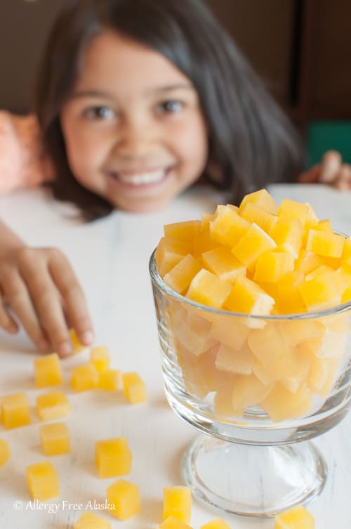 Bowl of real fruit gummies with child in the background