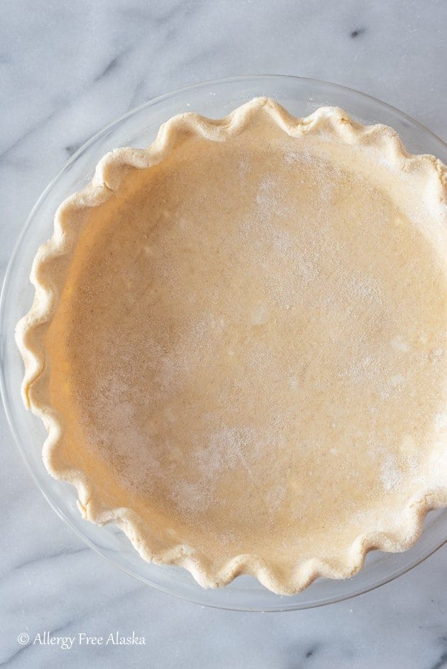 unbaked raw gluten-free pie crust in pie pan, ready for filling