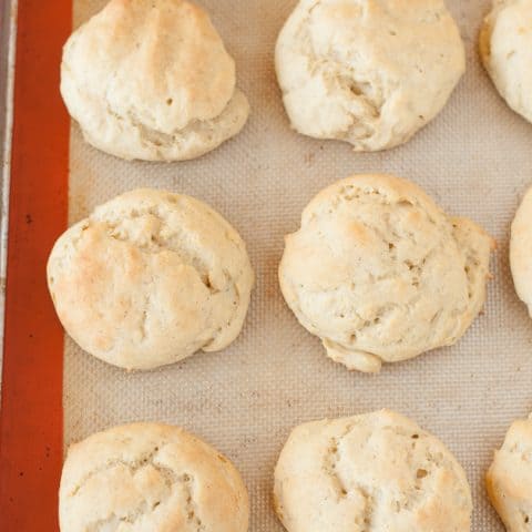 top down view of baked gluten-free rolls sitting on silpat lined baking sheet