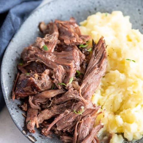 plate with chuck roast and mashed potatoes