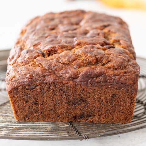 whole gluten-free banana bread loaf sitting on cooling rack