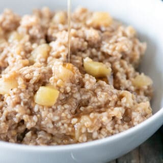 instant pot steel cut oats in white bowl with maple syrup being poured on it