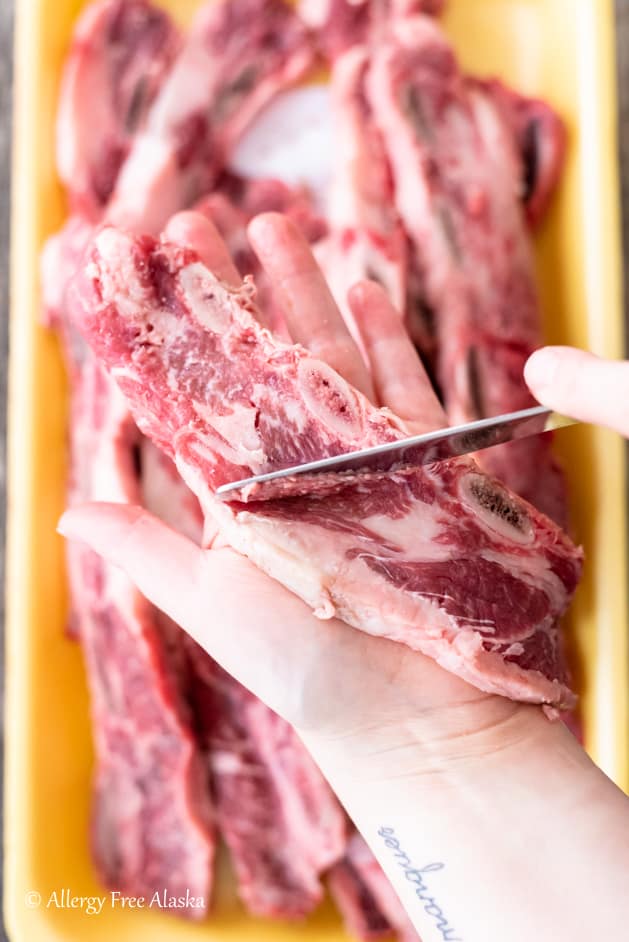 scraping beef rib with butter knife