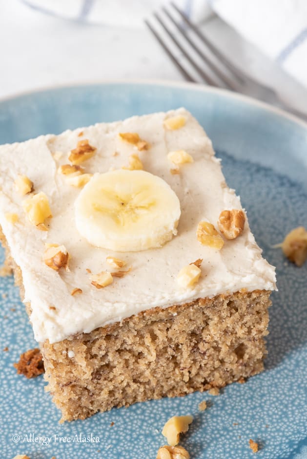 slice of gluten free dairy free banana cake sitting on blue plate from different angle