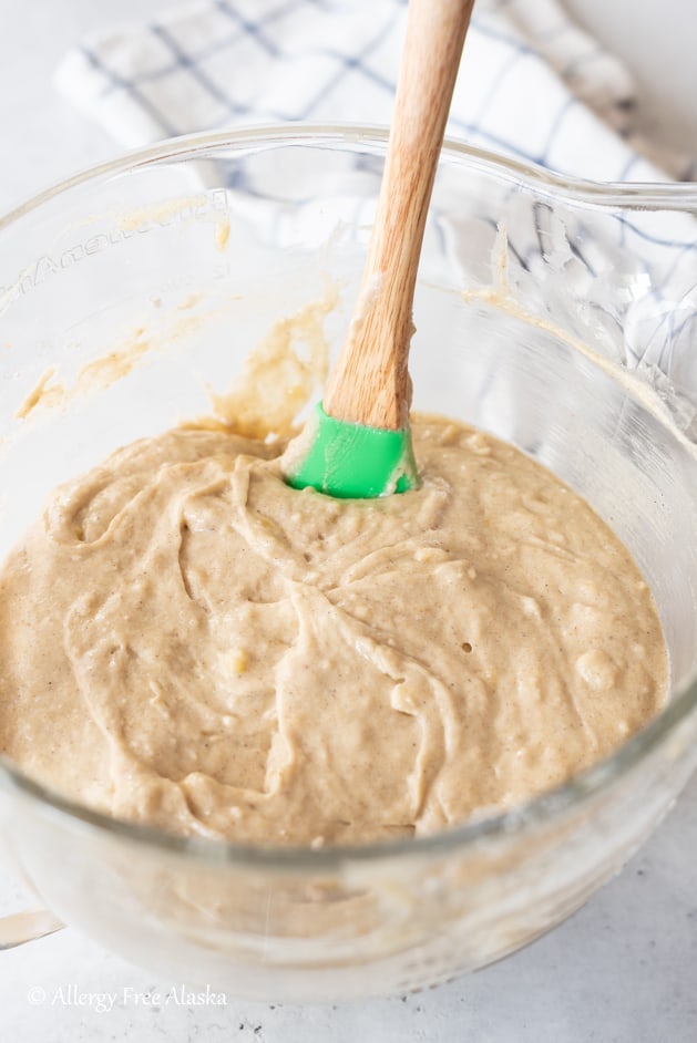 gluten-free banana cake batter in clear glass mixer bowl