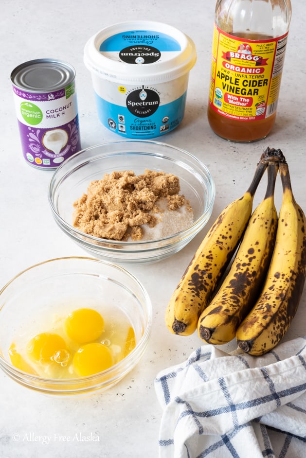 gluten free banana cake ingredients laid out on light gray background