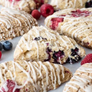 gluten free scones sitting on pastry board with berries