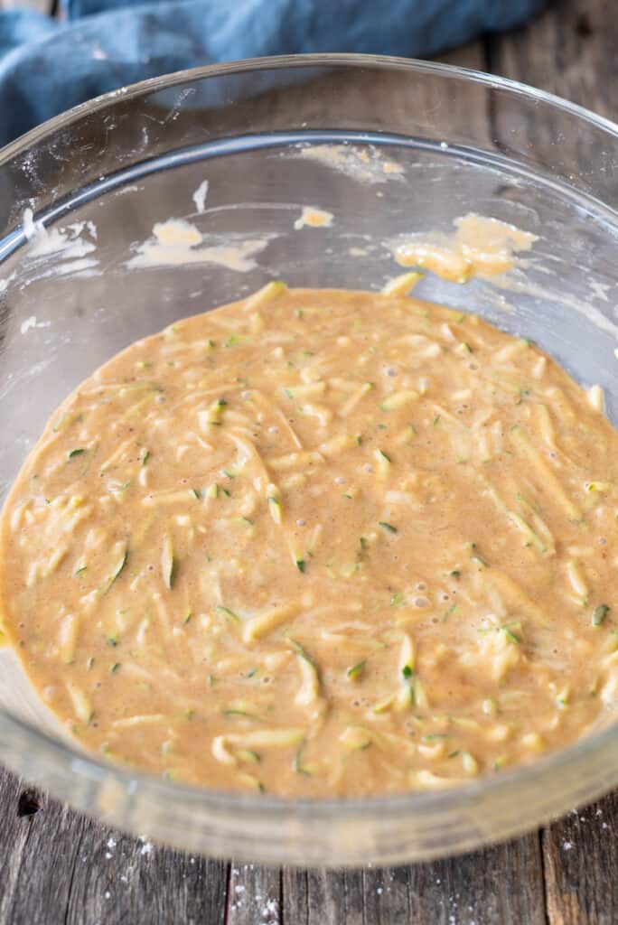raw zucchini muffin batter in large clear bowl