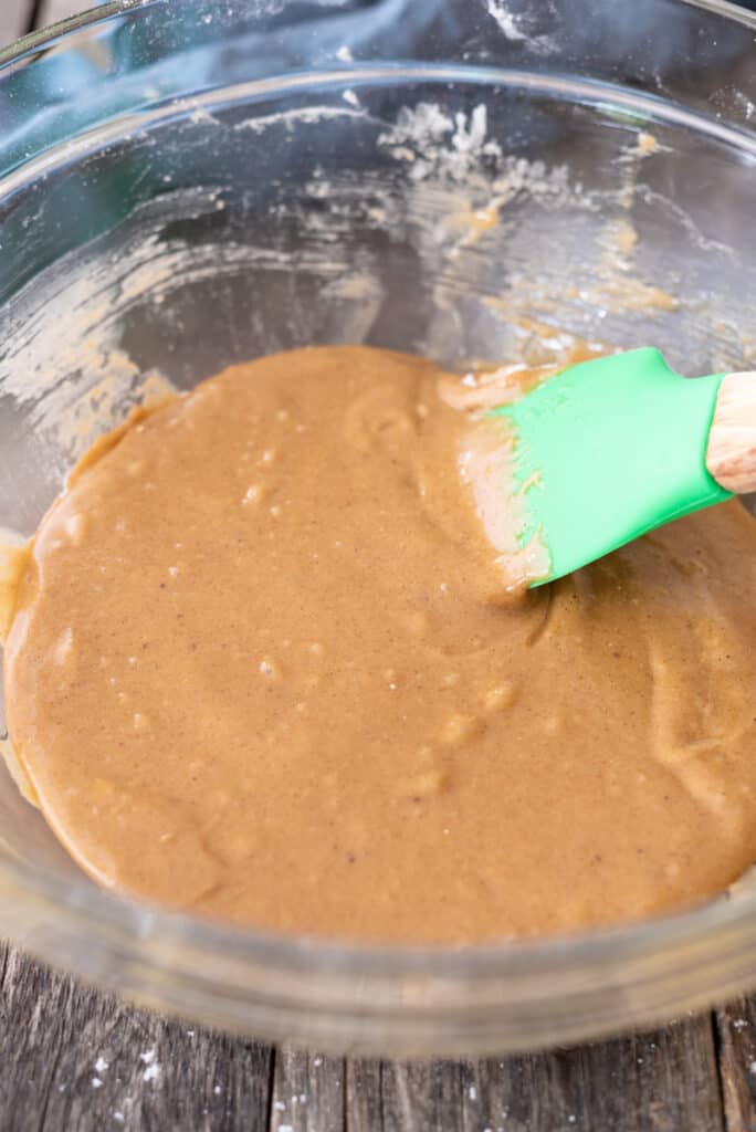 Raw zucchini muffin batter sitting in large clear bowl