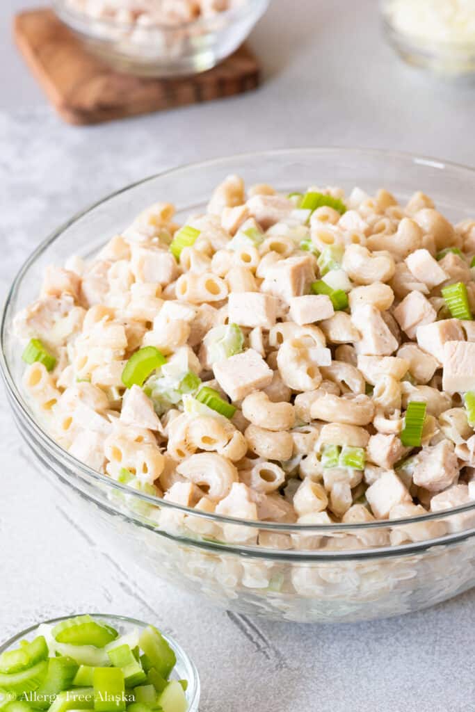 Side angle view of dairy free macaroni salad in clear bowl