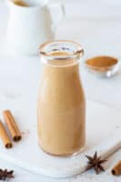 sugar free pumpkin spice creamer in a glass jar on a white background