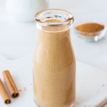 sugar free pumpkin spice creamer in a glass jar on a white background