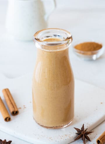 sugar free pumpkin spice creamer in a glass jar on a white background